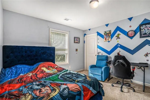 a bathroom with a granite countertop toilet sink and mirror