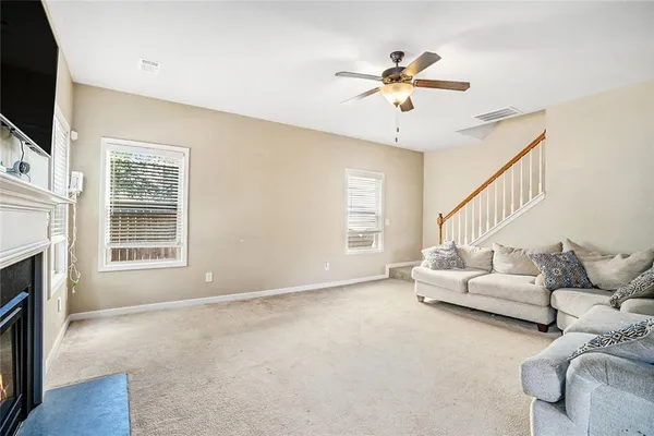 a living room with furniture fireplace and flat screen tv