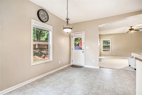 a kitchen with stainless steel appliances granite countertop a refrigerator a stove a sink and a microwave