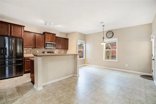 a kitchen with stainless steel appliances granite countertop a sink stove and cabinets