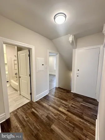 a view of an empty room and wooden floor