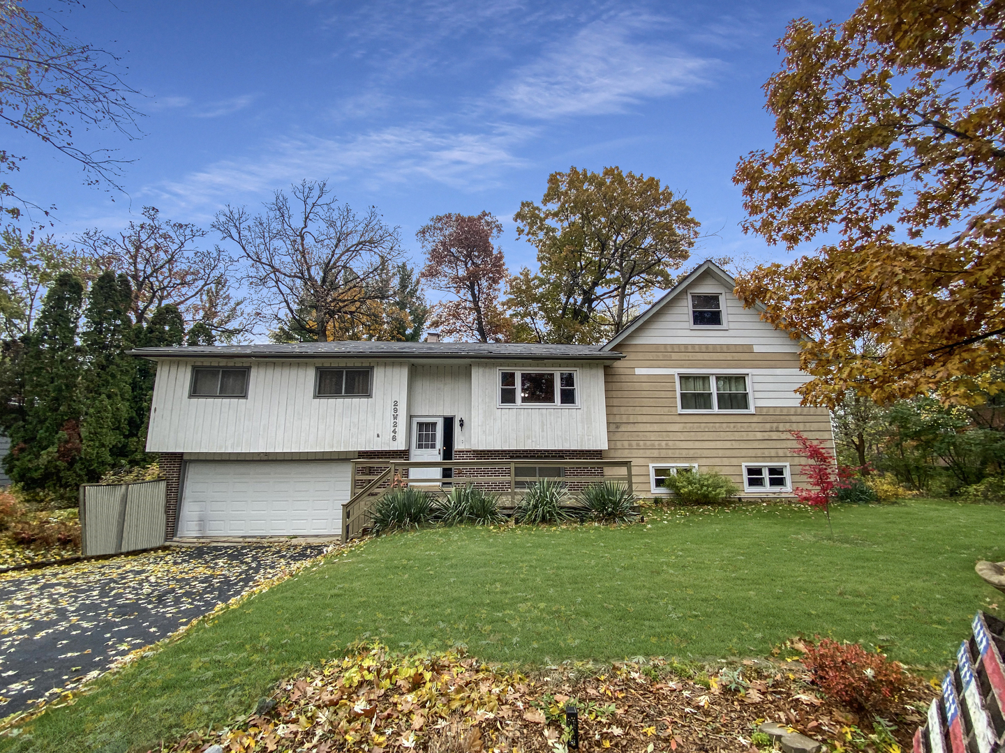 a front view of a house with a garden and yard