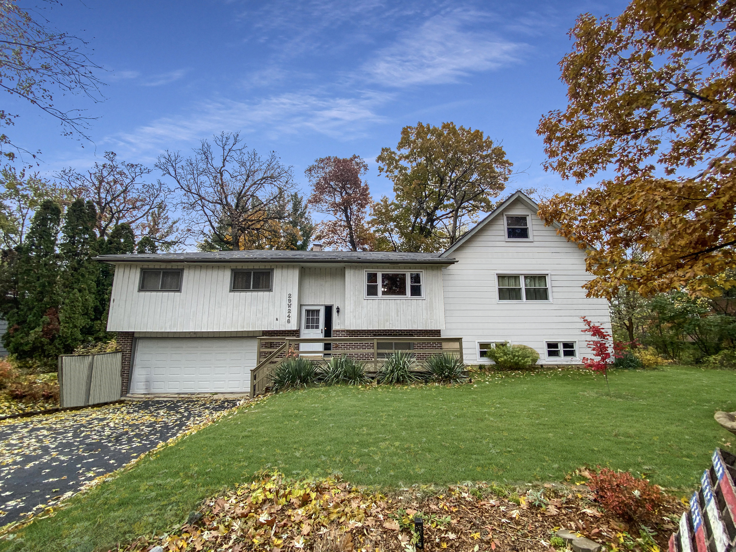 29W246 Lee Road West Chicago, IL 60185 - Photo 2 of 21 a front view of a house with a garden and yard