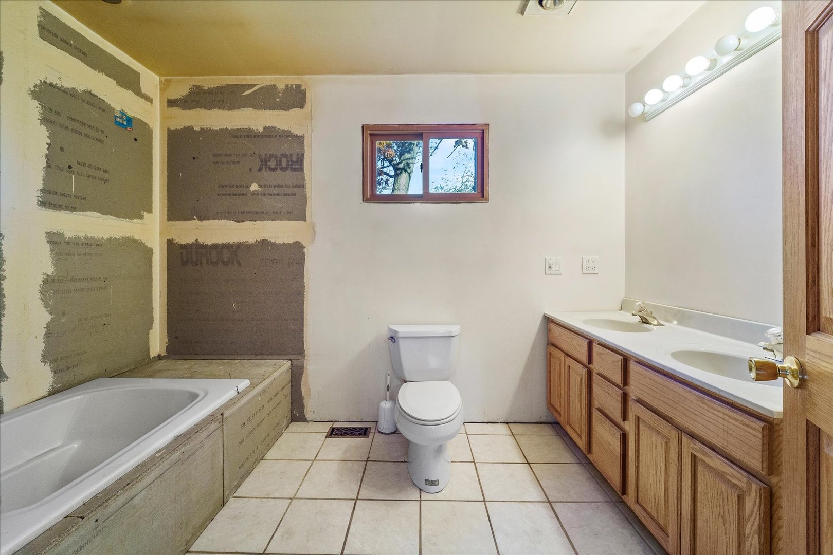 29W246 Lee Road West Chicago, IL 60185 - Photo 9 of 21 a bathroom with a double vanity sink toilet and shower