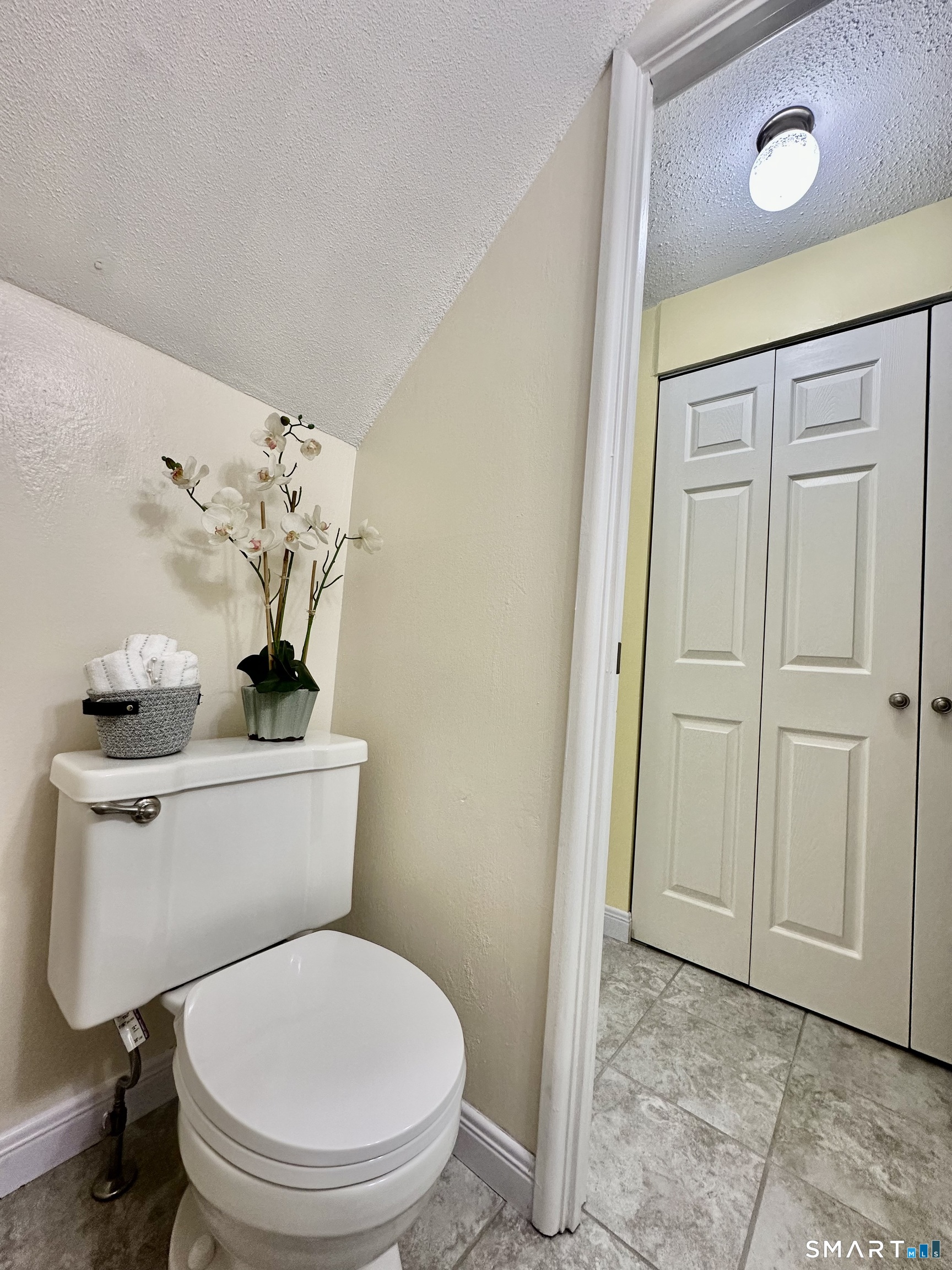 2 Lakeside Drive, Unit M Ledyard, CT 06339 - Photo 16 of 38 a white toilet sitting next to a bathroom sink