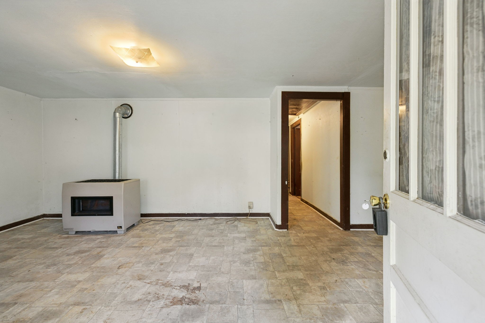 61 Brazzle Road Waverly, TN 37185 - Photo 6 of 36 a view of an empty room with a fireplace and a window
