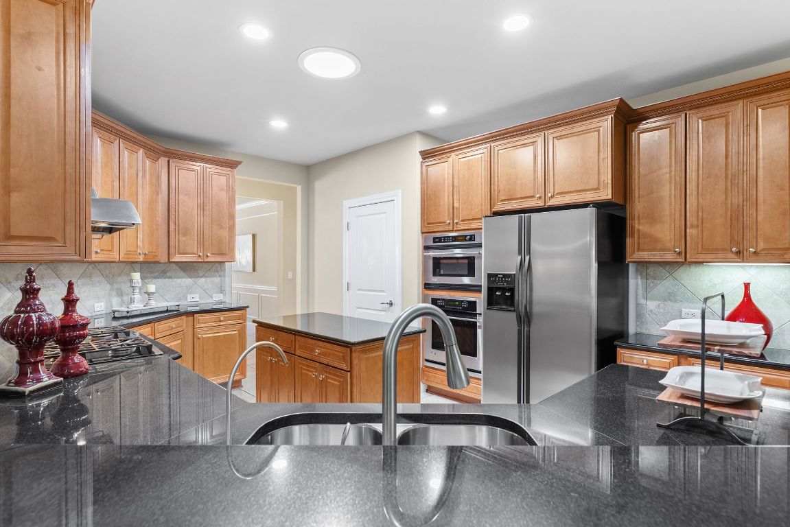 207 Cider Orchard Cove Georgetown, TX 78633 - Photo 16 of 35 a kitchen with stainless steel appliances granite countertop a refrigerator sink and cabinets