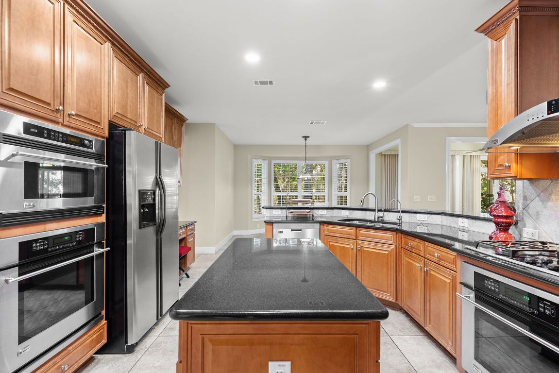 207 Cider Orchard Cove Georgetown, TX 78633 - Photo 18 of 35 a kitchen with stainless steel appliances granite countertop a stove top oven a sink and dishwasher