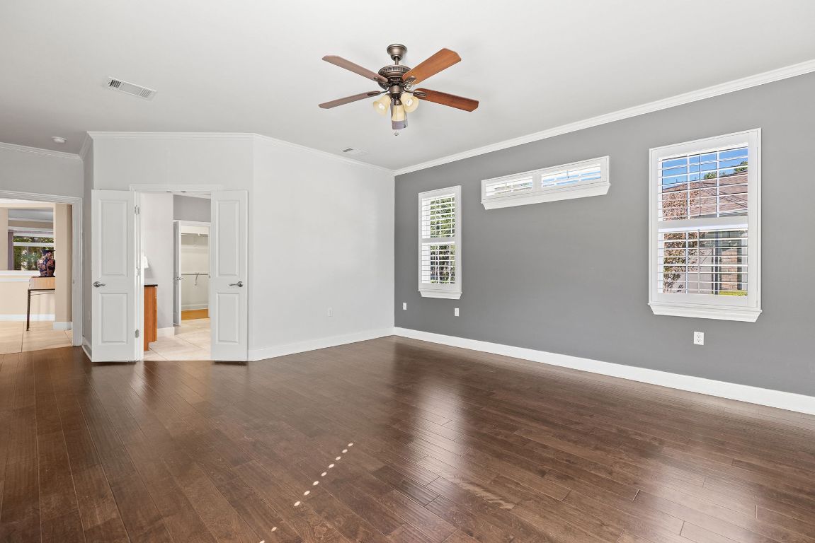 207 Cider Orchard Cove Georgetown, TX 78633 - Photo 24 of 35 a view of an empty room with window and wooden floor