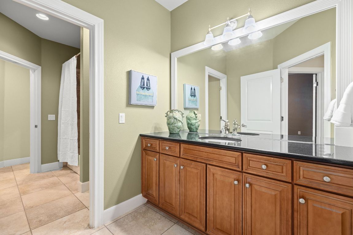 207 Cider Orchard Cove Georgetown, TX 78633 - Photo 30 of 35 a bathroom with a double vanity sink and a mirror