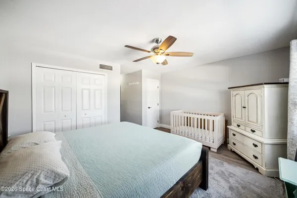 a bedroom with a bed and a chandelier