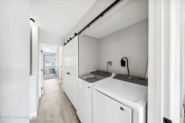 a view of storage and utility room with washer and dryer