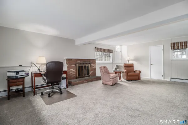 a living room with furniture and a fireplace
