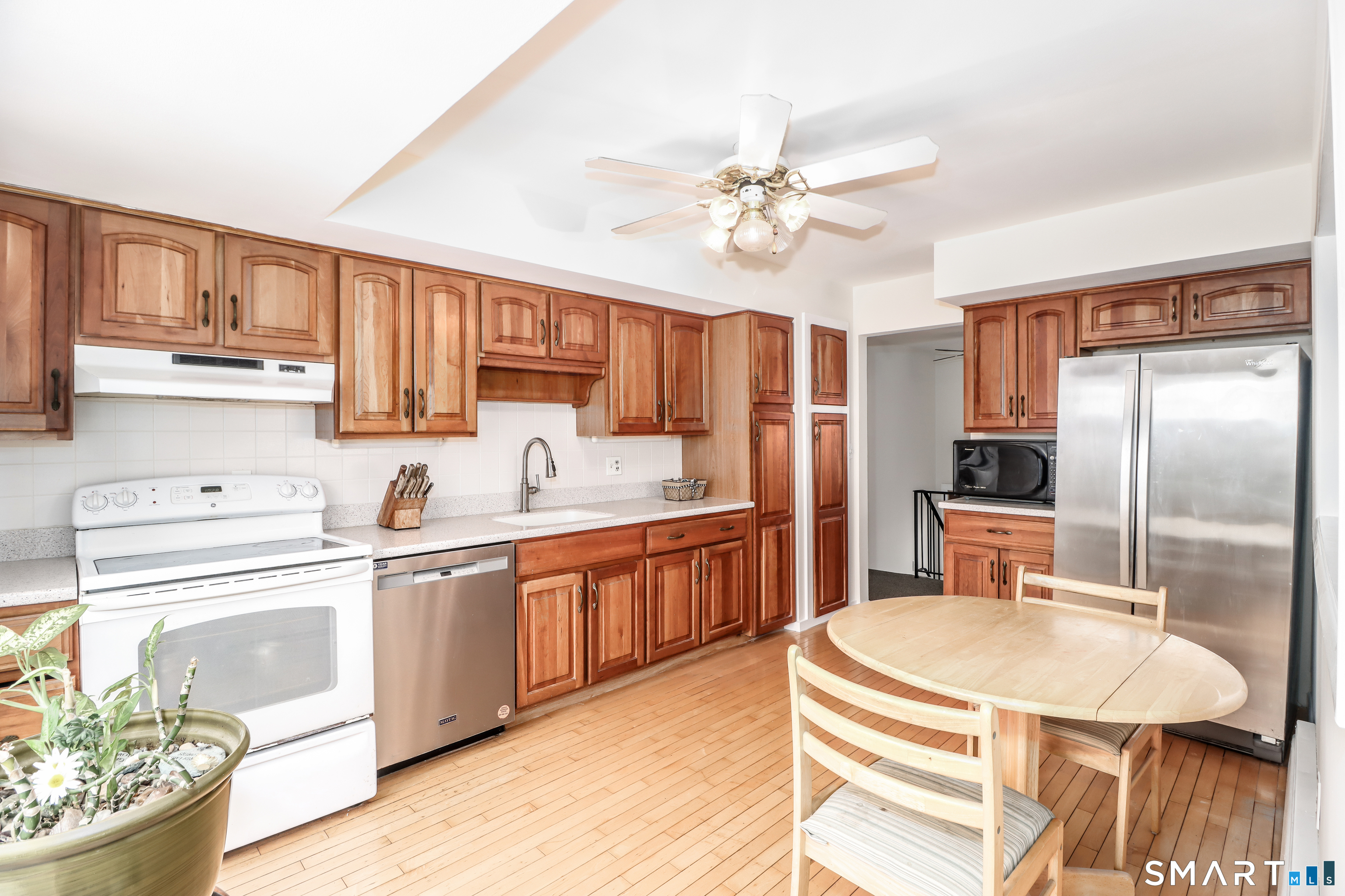 24 Prospect Drive Brookfield, CT 06804 - Photo 10 of 35 a kitchen with stainless steel appliances granite countertop a sink dishwasher a stove a refrigerator and island with wooden floor