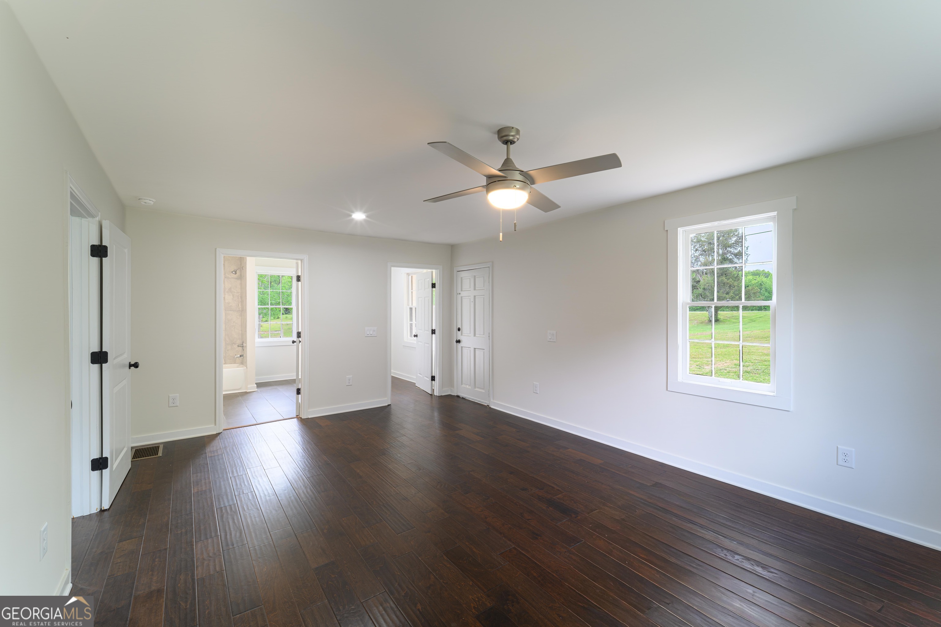 418 Lamb Road Moreland, GA 30259 - Photo 11 of 32 a view of an empty room with a window and wooden floor
