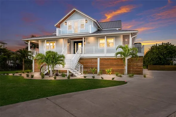 a front view of a house with a yard and porch