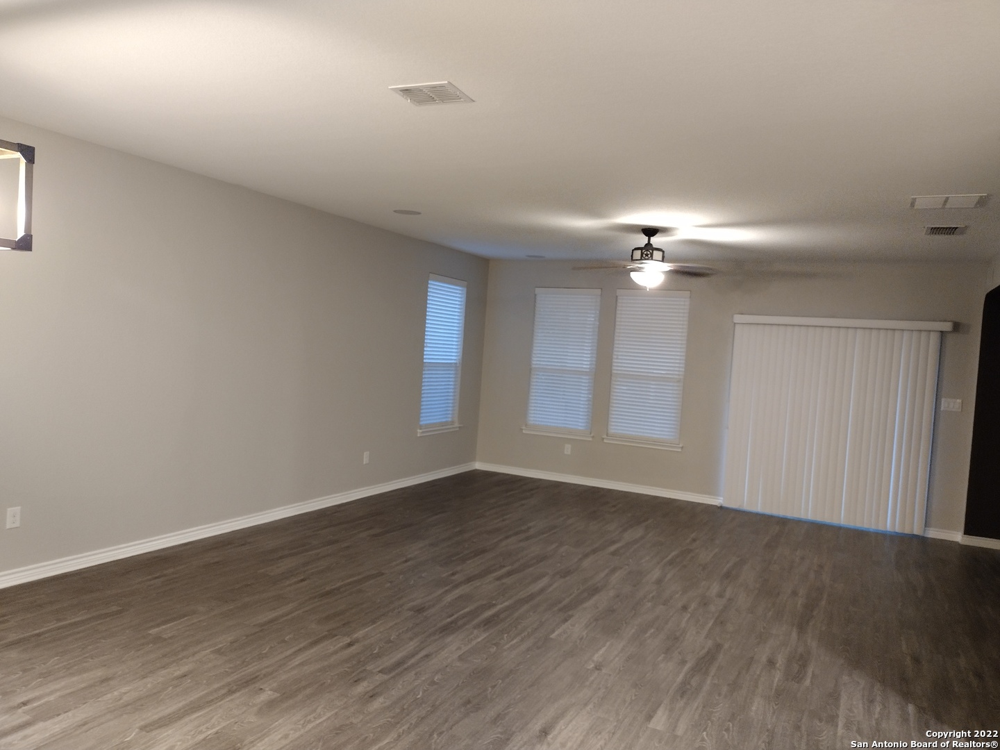 11212 Hill Top Loop Helotes, TX 78023 - Photo 20 of 34 a view of an empty room with wooden floor and a window