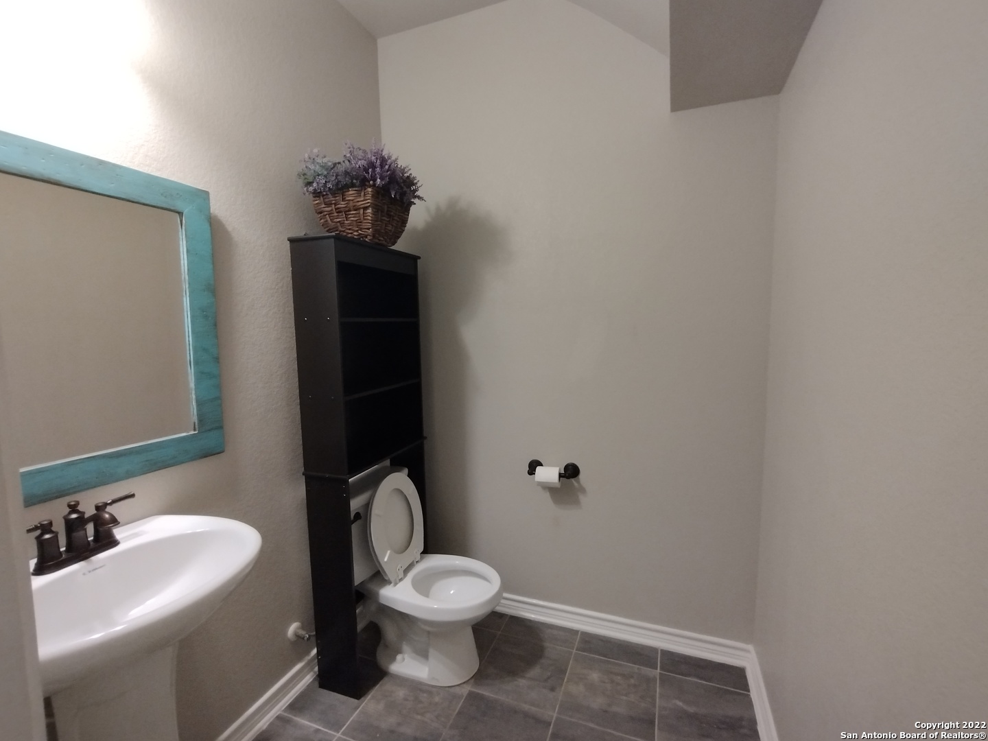 11212 Hill Top Loop Helotes, TX 78023 - Photo 23 of 34 a bathroom with a sink toilet and mirror