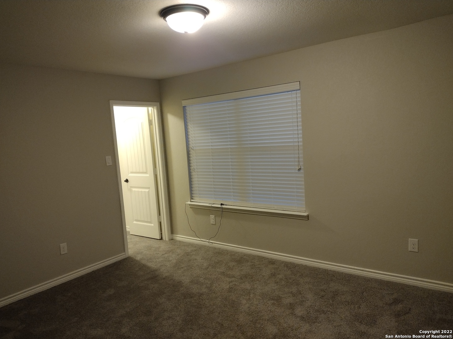 11212 Hill Top Loop Helotes, TX 78023 - Photo 24 of 34 an empty room with a window