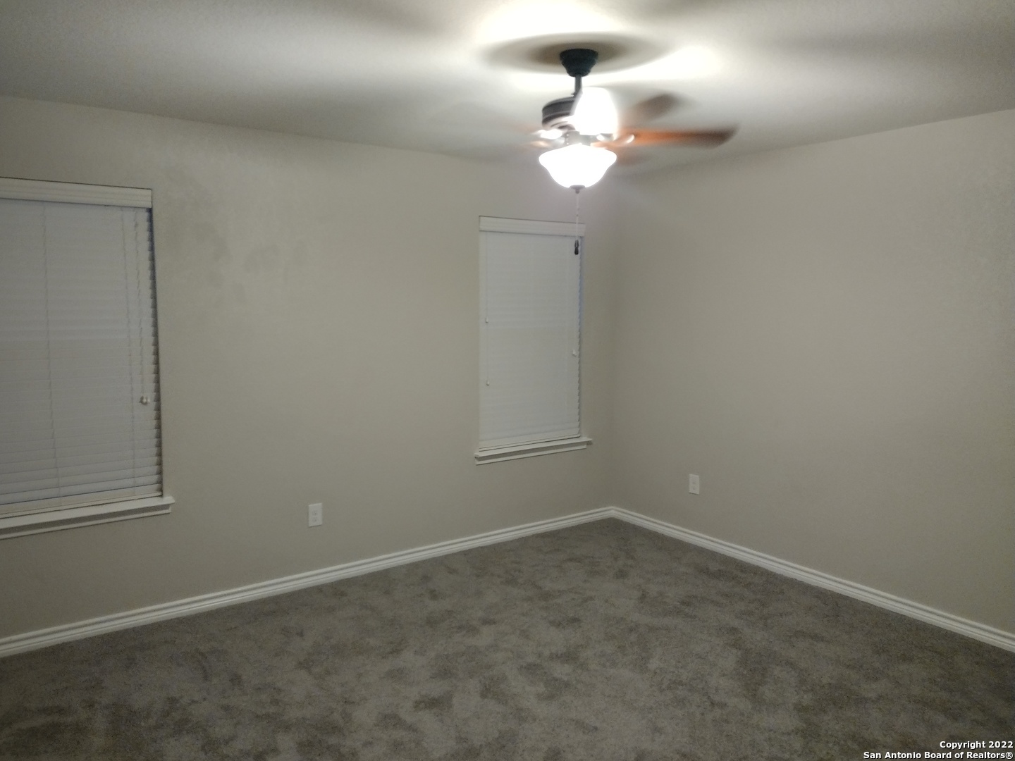 11212 Hill Top Loop Helotes, TX 78023 - Photo 27 of 34 an empty room with a chandelier fan