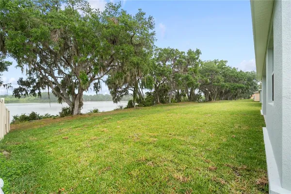 a view of outdoor space with green field and trees