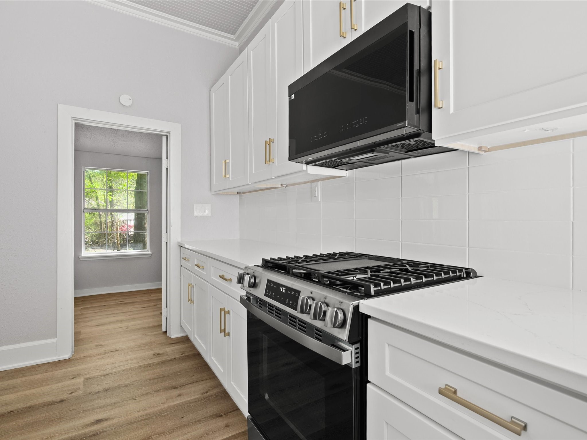 16958 Cedar Road Plantersville, TX 77363 - Photo 13 of 38 a kitchen with stainless steel appliances granite countertop a stove and a microwave