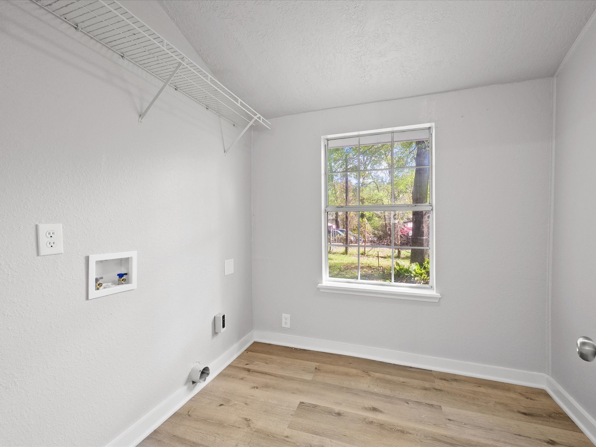 16958 Cedar Road Plantersville, TX 77363 - Photo 15 of 38 a view of an empty room with wooden floor and a window