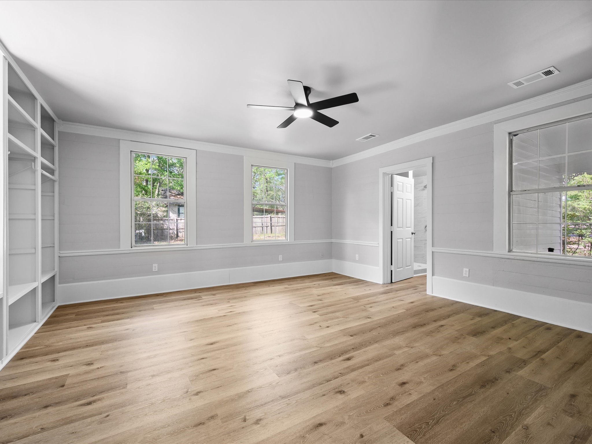 16958 Cedar Road Plantersville, TX 77363 - Photo 17 of 38 a view of an empty room with wooden floor and a window