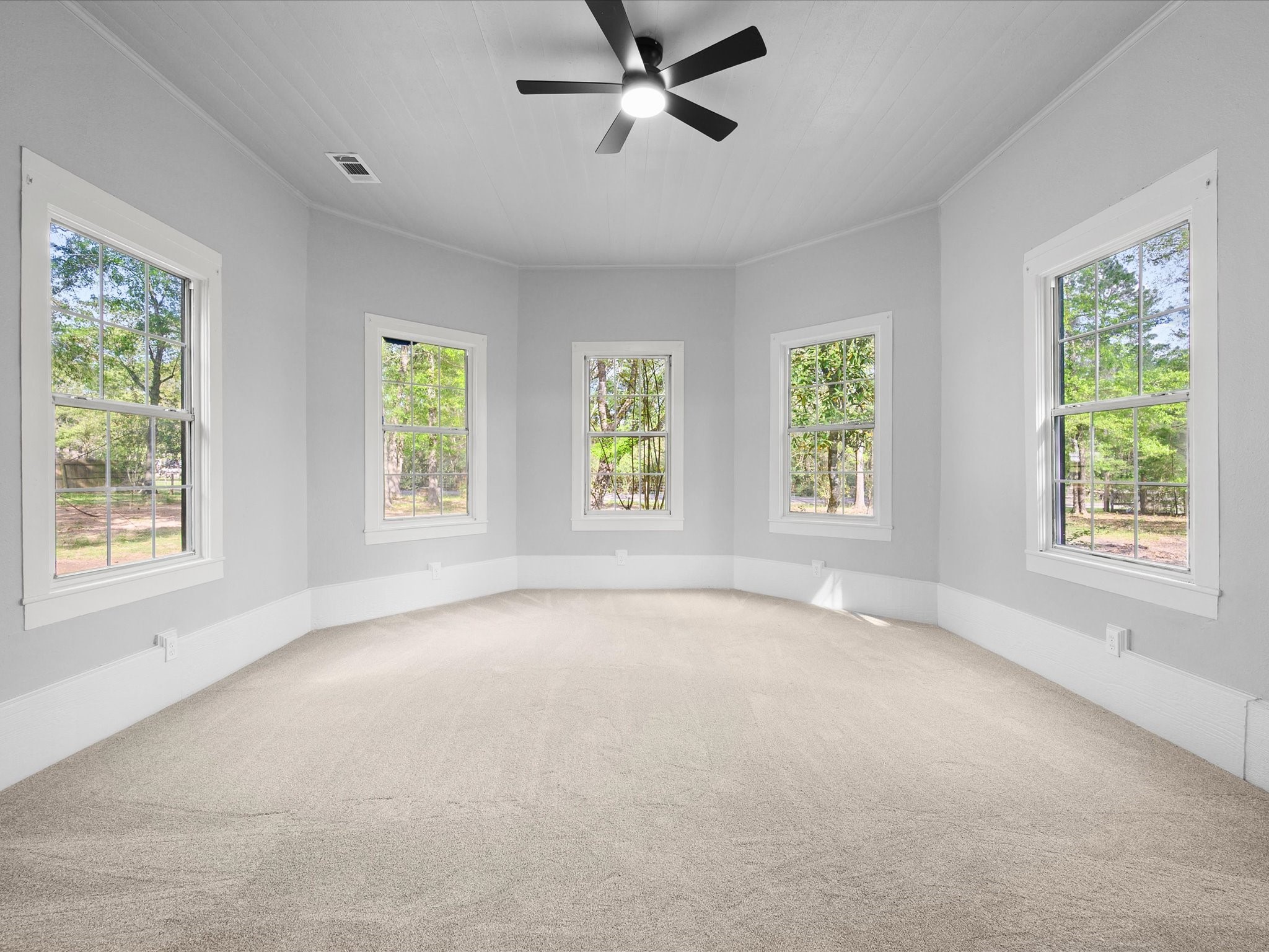 16958 Cedar Road Plantersville, TX 77363 - Photo 23 of 38 a view of an empty room with a window and a ceiling fan