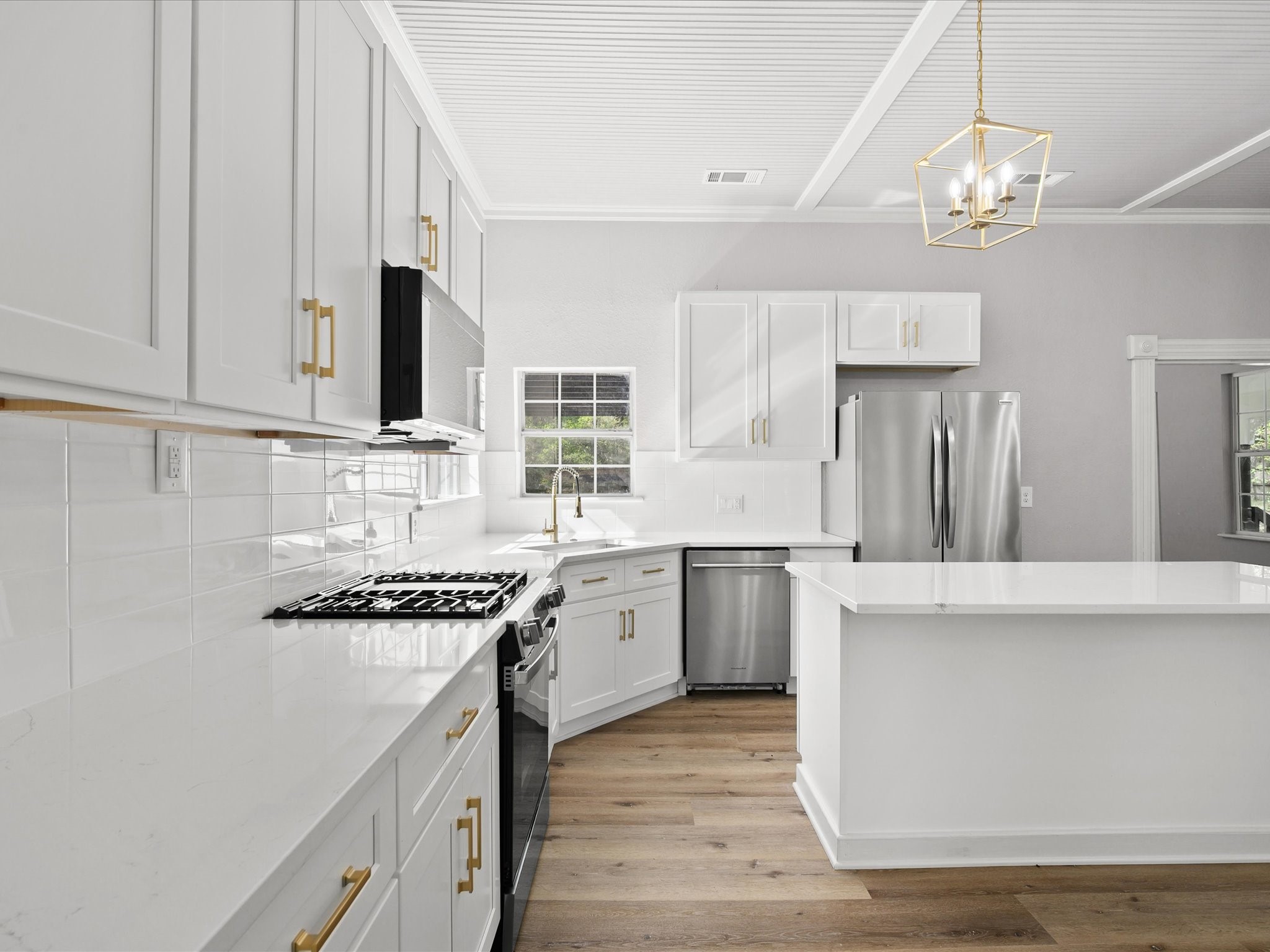16958 Cedar Road Plantersville, TX 77363 - Photo 10 of 38 a kitchen with stainless steel appliances a sink stove and cabinets