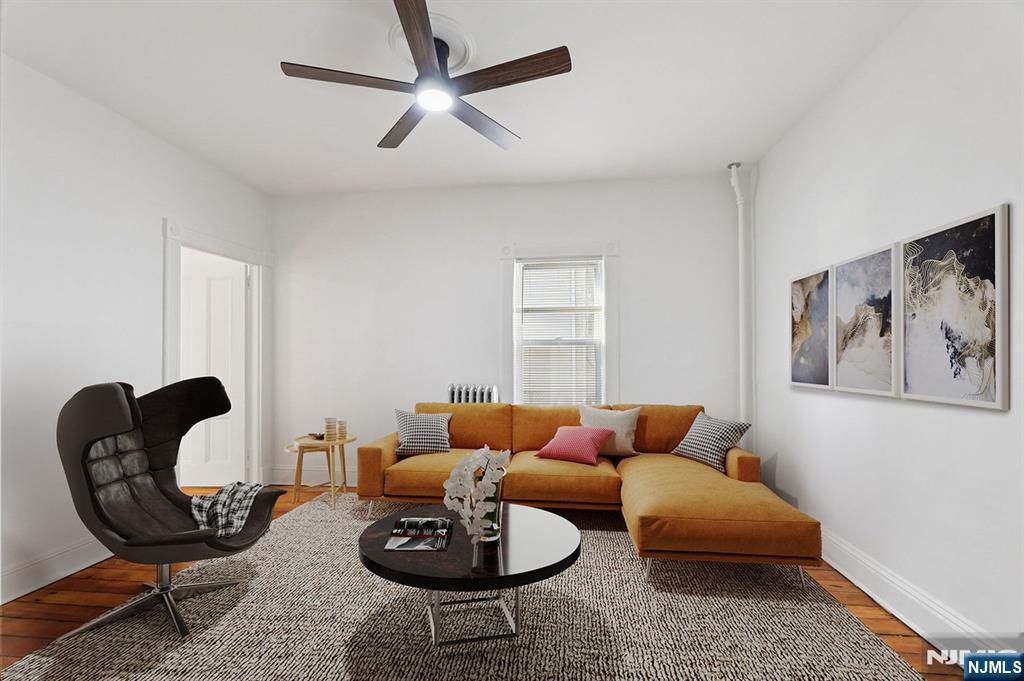 a living room with furniture a rug and a window