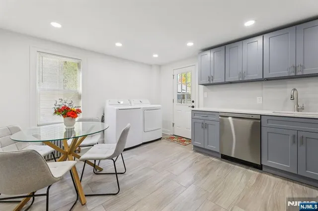 a kitchen with a sink cabinets and wooden floor