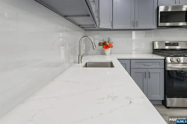 a kitchen with a sink and cabinets