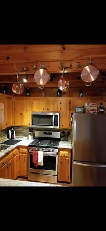 a kitchen with stainless steel appliances a stove and a microwave