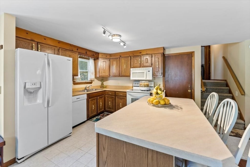 239 Ellendale Circle Springfield, MA 01128 - Photo 11 of 42 a kitchen with refrigerator cabinets and furniture