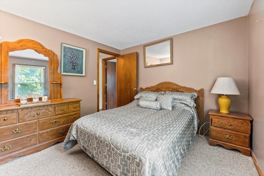 239 Ellendale Circle Springfield, MA 01128 - Photo 20 of 42 a bedroom with a bed and a lamp on dresser