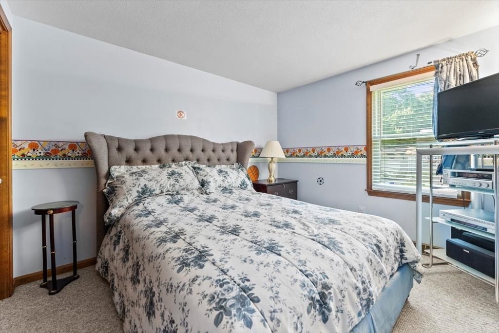 239 Ellendale Circle Springfield, MA 01128 - Photo 22 of 42 a bedroom with a bed and a flat screen tv