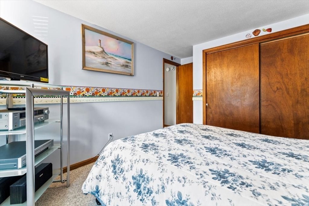 239 Ellendale Circle Springfield, MA 01128 - Photo 23 of 42 a bedroom with a bed and a flat screen tv