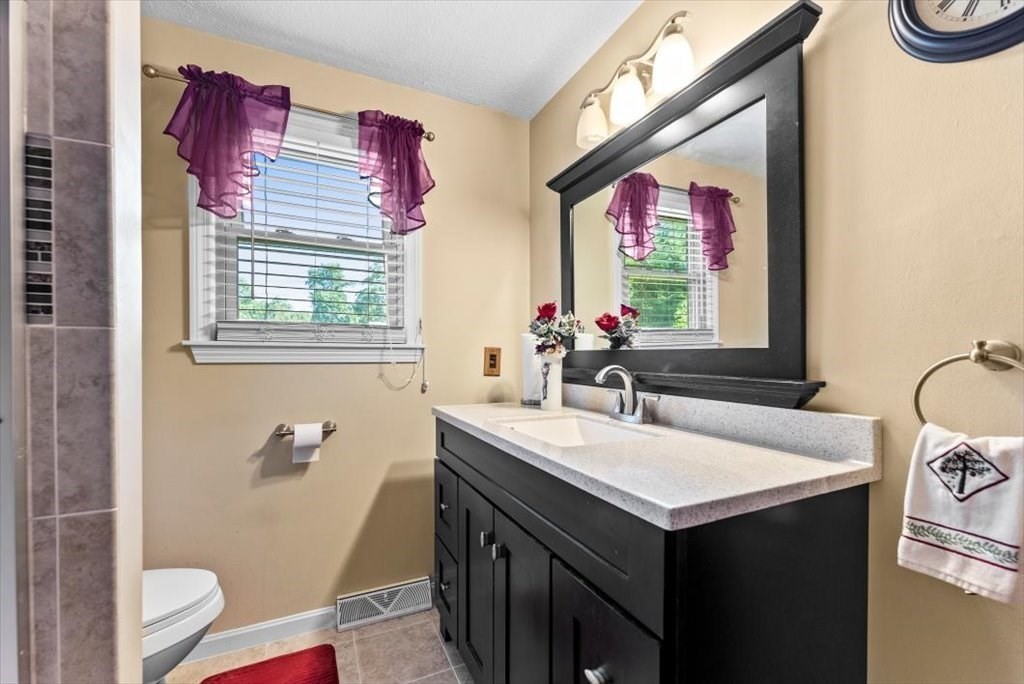 239 Ellendale Circle Springfield, MA 01128 - Photo 24 of 42 a bathroom with a sink vanity mirror and toilet