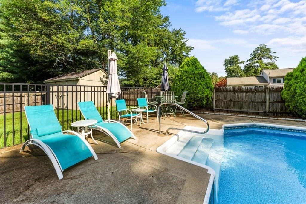 239 Ellendale Circle Springfield, MA 01128 - Photo 38 of 42 a view of a swimming pool with couches and wooden fence