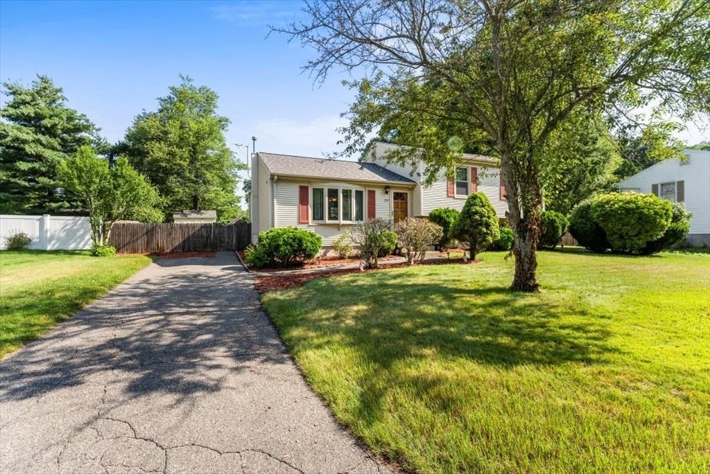 239 Ellendale Circle Springfield, MA 01128 - Photo 4 of 42 a front view of a house with garden and trees
