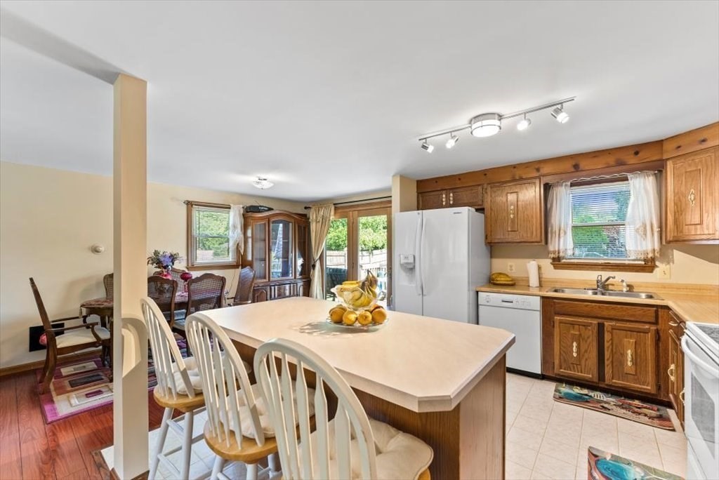 239 Ellendale Circle Springfield, MA 01128 - Photo 8 of 42 a kitchen with stainless steel appliances granite countertop a table chairs and a refrigerator