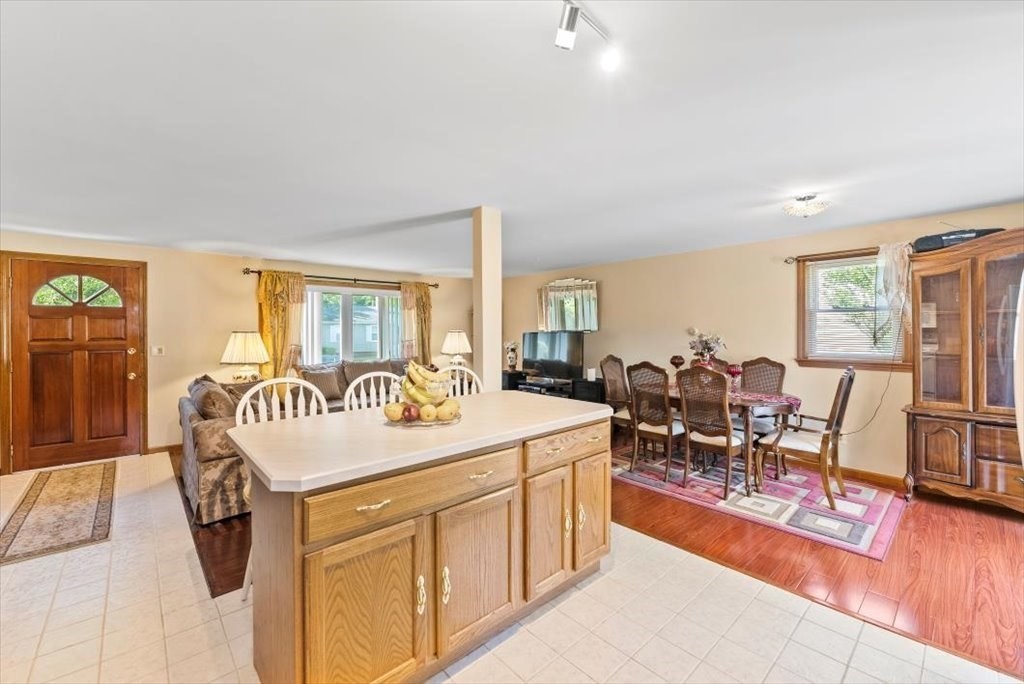 239 Ellendale Circle Springfield, MA 01128 - Photo 9 of 42 a living room with stainless steel appliances granite countertop furniture a desk and chair with wooden floor
