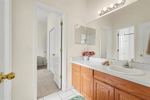 a bathroom with a sink double vanity granite tub and shower