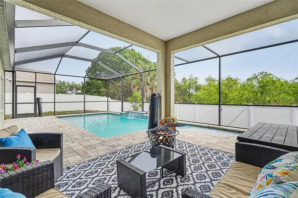 a view of a patio with a dining table and chairs