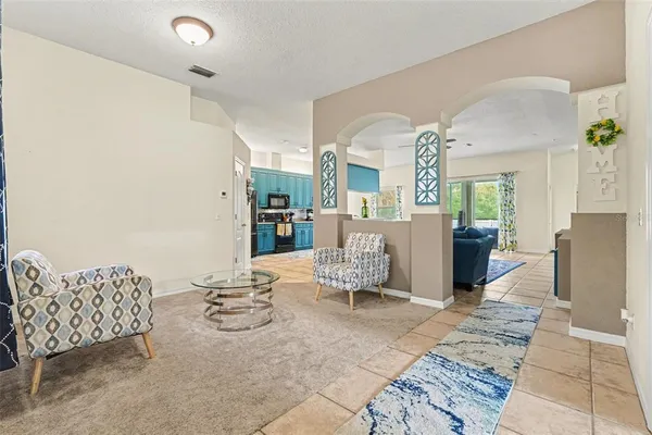 a living room with furniture and a dining table