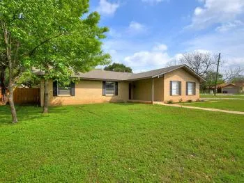 a view of a house with a backyard