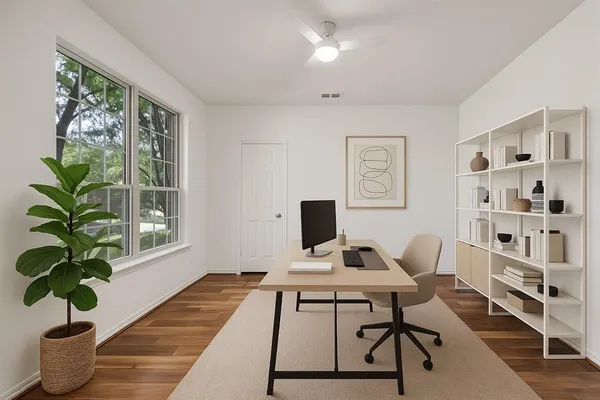a view of a workspace with furniture and a potted plant