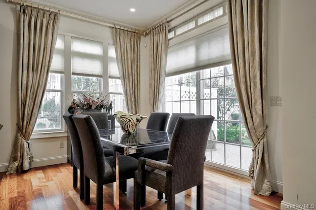 a view of a dining room with furniture window and wooden floor