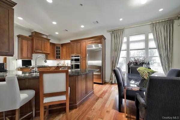 a kitchen with stainless steel appliances granite countertop sink stove top oven and cabinets